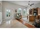 Inviting foyer features natural light from the front door and arched windows, plus a comfortable accent chair at 461 Luna Bella Ln, New Smyrna Beach, FL 32168