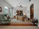 Bright home office featuring wood floors, a ceiling fan, and a large wooden desk and bookshelf at 461 Luna Bella Ln, New Smyrna Beach, FL 32168