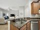 Kitchen featuring granite countertops, stainless steel dishwasher and view into living room at 461 Luna Bella Ln, New Smyrna Beach, FL 32168