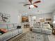 Spacious living area with a seamless flow to other living areas, featuring dual recliners and bright lighting at 461 Luna Bella Ln, New Smyrna Beach, FL 32168