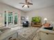 Comfortable living room featuring leather sofas, a ceiling fan, and sliding doors that open to a screened patio at 461 Luna Bella Ln, New Smyrna Beach, FL 32168