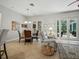 Open concept living room with tile floors, dining area, and furniture at 461 Luna Bella Ln, New Smyrna Beach, FL 32168