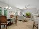 Open concept living room with tile floors, ceiling fan, and dining area near french doors at 461 Luna Bella Ln, New Smyrna Beach, FL 32168
