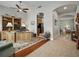 Spacious home office with hardwood accents, a large desk, and seamless flow into the kitchen and living areas at 461 Luna Bella Ln, New Smyrna Beach, FL 32168