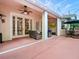 Spacious patio with dining and seating areas, seamlessly blending indoor and outdoor living spaces at 461 Luna Bella Ln, New Smyrna Beach, FL 32168