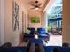 Cozy patio area with comfortable seating, a ceiling fan, and a wall-mounted television for outdoor entertainment at 461 Luna Bella Ln, New Smyrna Beach, FL 32168
