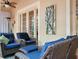 Relaxing patio seating area with stylish decor, offering a perfect spot to unwind and enjoy the outdoors at 461 Luna Bella Ln, New Smyrna Beach, FL 32168