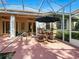 Charming outdoor patio with dining table and comfortable seating, ideal for enjoying meals and gatherings at 461 Luna Bella Ln, New Smyrna Beach, FL 32168