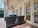 Cozy outdoor patio with comfortable seating, ceiling fan, and easy access to the indoors at 461 Luna Bella Ln, New Smyrna Beach, FL 32168