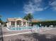 Community pool with lounge chairs and covered area for relaxing by the water at 461 Luna Bella Ln, New Smyrna Beach, FL 32168