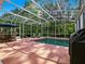 Relaxing screened-in pool and lanai, surrounded by lush greenery at 461 Luna Bella Ln, New Smyrna Beach, FL 32168