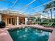 Inviting screened-in pool area with lounge chairs, patio furniture, and clear views of the blue sky above at 461 Luna Bella Ln, New Smyrna Beach, FL 32168
