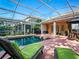 Relaxing screened-in pool area with green lounge chairs, perfect for enjoying sunny days in comfort at 461 Luna Bella Ln, New Smyrna Beach, FL 32168