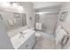 Bright, clean bathroom with white vanity, tub shower, and ample mirror space for daily routines at 4777 S Atlantic Ave # B2, Port Orange, FL 32127