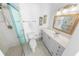 Clean bathroom featuring glass shower, modern vanity with marble countertops and beach themed decor at 4777 S Atlantic Ave # B2, Port Orange, FL 32127