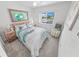 Inviting bedroom with soft colors, a comfortable bed, and natural light from the nearby window at 4777 S Atlantic Ave # B2, Port Orange, FL 32127