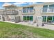 Condo back patios with white furniture, green space, and ocean views at 4777 S Atlantic Ave # B2, Port Orange, FL 32127