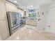 Well-lit kitchen with modern stainless steel appliances and bright white cabinets at 4777 S Atlantic Ave # B2, Port Orange, FL 32127