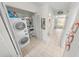 Efficient laundry area with a stackable washer and dryer and access to hallway and views at 4777 S Atlantic Ave # B2, Port Orange, FL 32127
