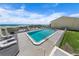 Community pool deck and chairs with ocean view on a sunny day at 4777 S Atlantic Ave # B2, Port Orange, FL 32127