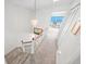 Bright staircase leading to an open space, with a view of the ocean and access to the balcony at 4777 S Atlantic Ave # B2, Port Orange, FL 32127