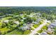 An aerial view of a home in a quiet neighborhood surrounded by lush trees and greenery at 505 Sandale Ct, Deland, FL 32724