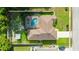 Aerial view of the property showcasing the pool, surrounding greenery, and defining property lines at 505 Sandale Ct, Deland, FL 32724