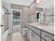 Bathroom with double vanity, bright lighting, and a door leading to the pool area at 505 Sandale Ct, Deland, FL 32724