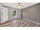Cozy bedroom with a ceiling fan, hardwood flooring, and a window with a view at 505 Sandale Ct, Deland, FL 32724