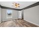 Spacious bedroom featuring a ceiling fan, natural light, and ample closet space at 505 Sandale Ct, Deland, FL 32724