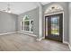 Bright entryway featuring wood-look tile flooring, arched doorways, and a decorative glass front door at 505 Sandale Ct, Deland, FL 32724