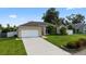 Charming single-story home with a manicured lawn and a spacious driveway leading to a two-car garage at 505 Sandale Ct, Deland, FL 32724
