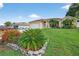 A well-maintained home with a manicured front yard featuring vibrant landscaping and a spacious driveway at 505 Sandale Ct, Deland, FL 32724