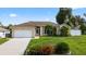 Beautiful single-story home with lush landscaping, a well-maintained lawn, and a spacious driveway at 505 Sandale Ct, Deland, FL 32724