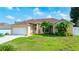 Charming single-story home with a well-maintained lawn and lovely tropical landscaping at 505 Sandale Ct, Deland, FL 32724