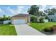 Charming home with a well-manicured lawn, a paved driveway, and an attached garage at 505 Sandale Ct, Deland, FL 32724