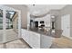 This open kitchen features white cabinets, stainless steel appliances, and a breakfast bar with views of the pool at 505 Sandale Ct, Deland, FL 32724