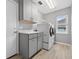 Functional laundry room with modern washer/dryer, cabinetry, and a window for natural light at 505 Sandale Ct, Deland, FL 32724