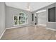 Bright and airy living room with large windows, ceiling fan, and modern flooring creating an inviting space at 505 Sandale Ct, Deland, FL 32724