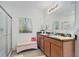 Bright bathroom featuring a double sink vanity, glass-enclosed shower, neutral color scheme, and modern fixtures at 518 Safe Harbor Dr, Edgewater, FL 32141