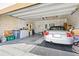 Spacious garage with ample storage, washer, dryer, and a silver convertible car at 518 Safe Harbor Dr, Edgewater, FL 32141