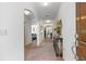Inviting hallway with elegant archways, neutral carpet, and decorative console table, leading to various rooms at 518 Safe Harbor Dr, Edgewater, FL 32141