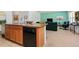 Open concept kitchen featuring wood cabinets, black appliances, a kitchen island, and a view to the living area at 518 Safe Harbor Dr, Edgewater, FL 32141
