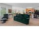 Spacious living room with a comfortable green sofa, black recliner and a view of the dining area and kitchen at 518 Safe Harbor Dr, Edgewater, FL 32141