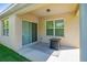 Cozy covered patio with sliding glass doors, an outdoor rug, and a small table, perfect for relaxing at 518 Safe Harbor Dr, Edgewater, FL 32141