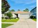 Charming single-story home with a well-manicured lawn and attached two-car garage at 520 Aeolian Dr, New Smyrna Beach, FL 32168