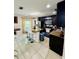 Modern kitchen with stainless steel appliances, a breakfast bar, and dark cabinetry at 520 Aeolian Dr, New Smyrna Beach, FL 32168