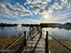 Wooden community dock extending over a peaceful lake, creating a serene atmosphere for residents to enjoy at 5263 Bear Corn Run, Port Orange, FL 32128