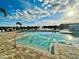 A community pool features a clear blue swimming area and a tranquil lake view at 5263 Bear Corn Run, Port Orange, FL 32128