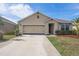 Charming single-story home with a two-car garage, landscaped yard, and inviting curb appeal at 5263 Bear Corn Run, Port Orange, FL 32128